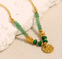 Green beaded necklace with gold charm