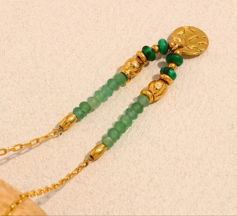 Green beaded necklace with gold charm
